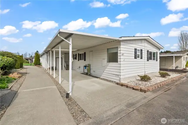 Shot of home by carport-day time