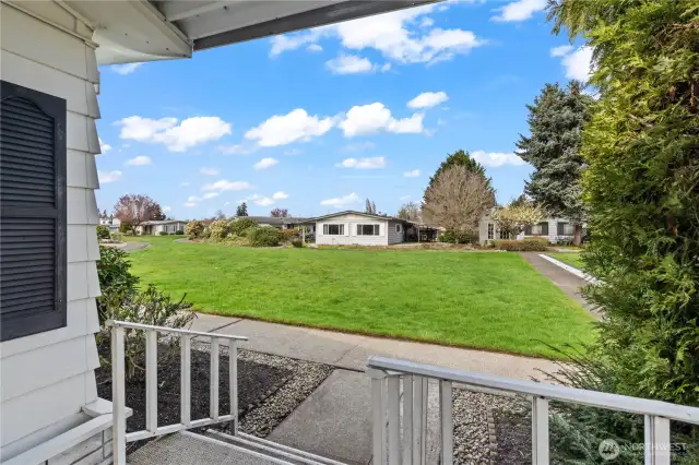 View of large grass area from front porch