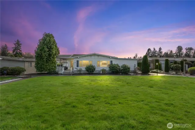 Shot of home from side by large grass area
