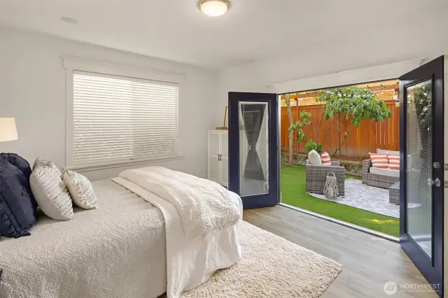 Primary bedroom on the lowest level with French doors walking out to nice private, fenced, backyard space.