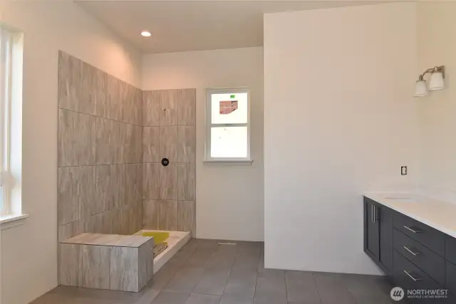 Primary bathroom. The shower will have glass doors, and a soaking tub will be installed beneath the window.