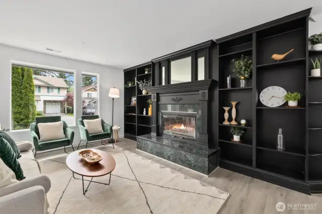 Wood burning fireplace with gorgeous black mantel and built-in shelving