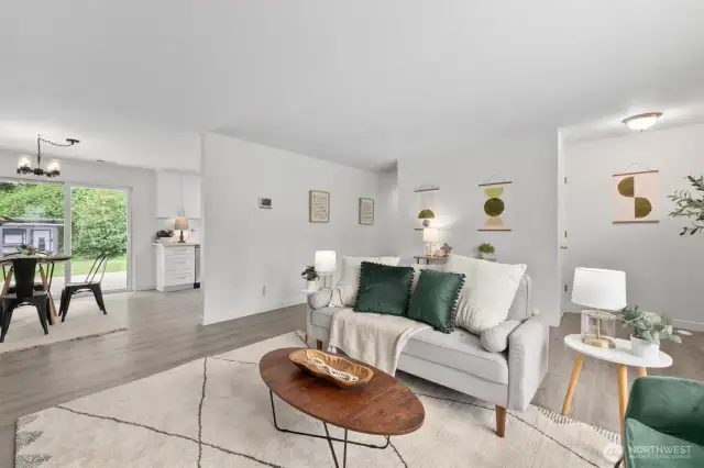 Living room, dining area and kitchen all flow seamlessly with new LVP flooring throughout the home