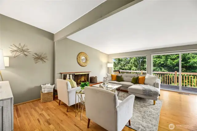Living Room opens to outdoor deck above swimming pool and greenbelt.
