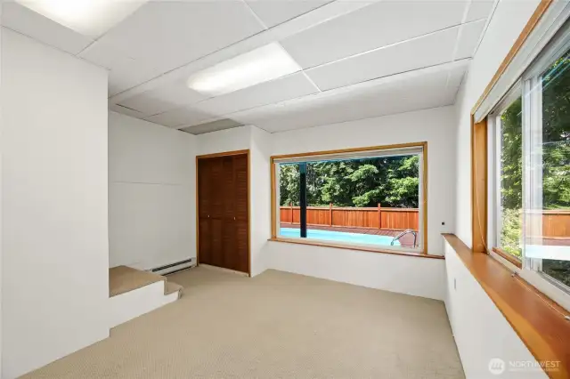 Downstairs bedroom or home office that overlooks the pool and greenbelt.