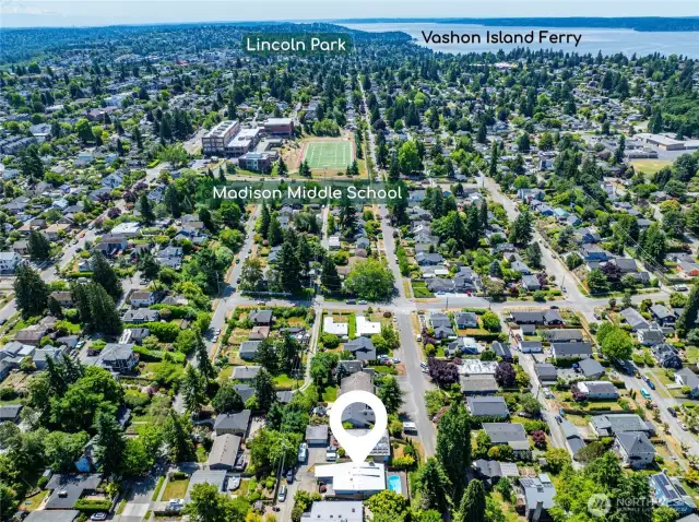 Drone shot includes property with Madison Middle School a few blocks south, and Lincoln Park and Vashon Ferry in the distance.