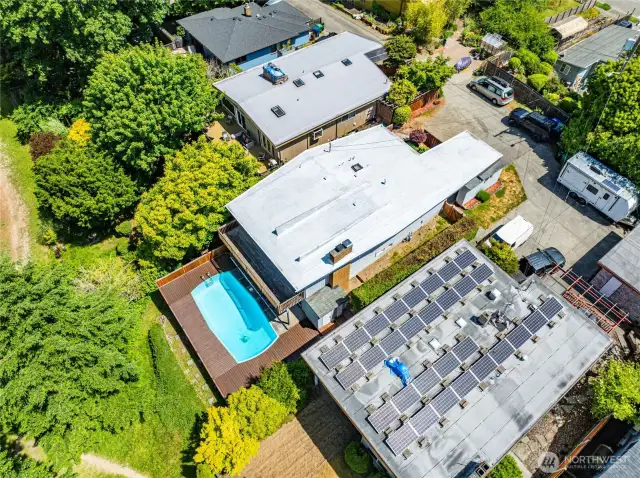 Overhead drone shot of the property. The east/pool side of property privately looks out over public greenbelt and path. The greenbelt is a special piece of property in this neighborhood, contributing some extra green/flex space.