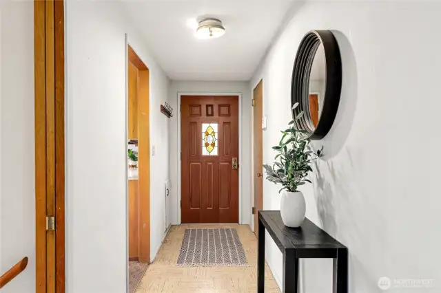 Interior shot of entry door with kitchen entry to the left and stairs to basement in the foreground. This seller was the original owner of the property (1963).
