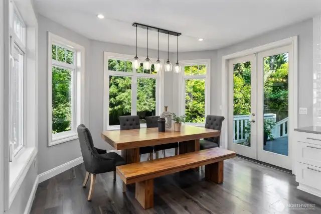 Dining space designed to bring the outdoors in with abundant natural light and garden views.