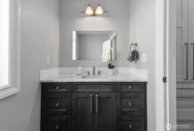 A sophisticated powder bath on the main level with stunning Carrara marble details.