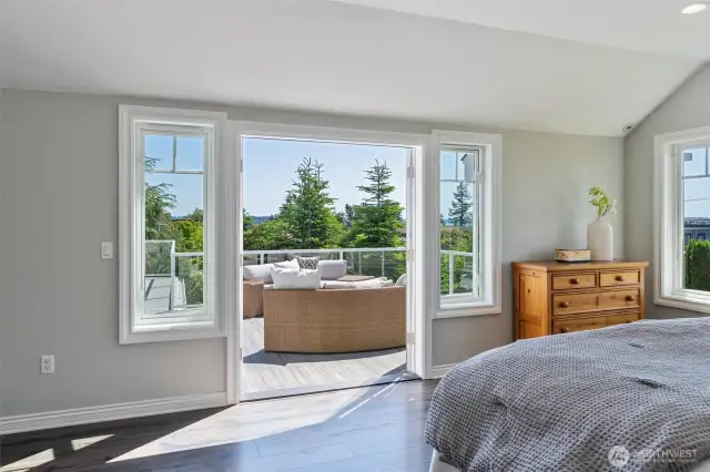 Wake up to breathtaking views in the primary suite that opens to a vast deck.