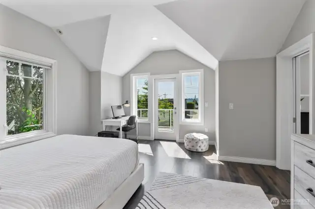 Light-filled en-suite bedroom with vaulted ceilings, private deck access, and a serene work-from-home nook.