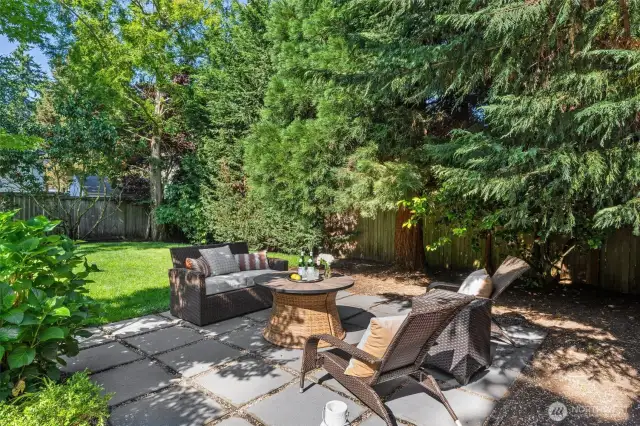 Tranquil outdoor patio offers the perfect spot to unwind, surrounded by peaceful landscaping and ideal for morning coffee or evening relaxation.