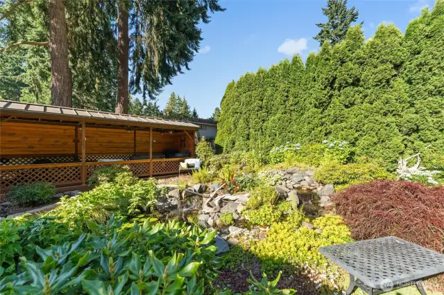The sound of tranquil waterfall feature including Koi, goldfish, and blown glass yard art.