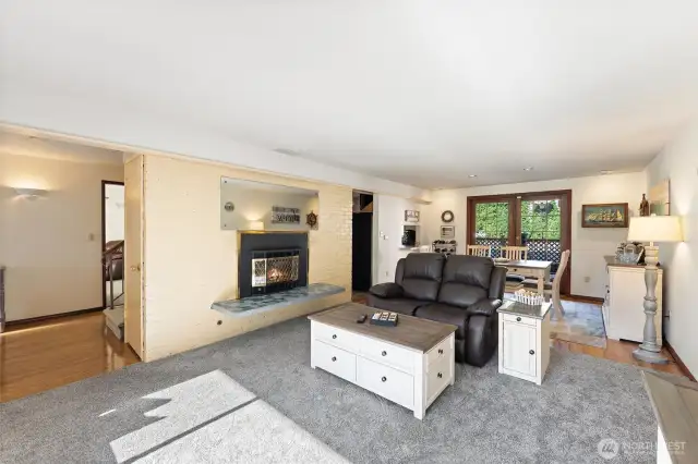 Spacious living room, gas fireplace, and French doors.