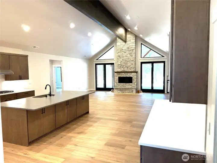 Beautiful vaulted ceilings with stone fireplace and large island.