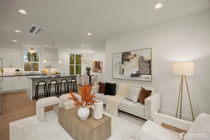 Living room open to kitchen and dining areas.