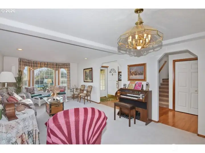 Grand entrance opens to a bright and spacious living room.