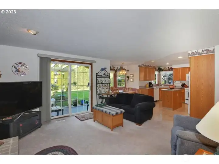 Family room flows into the kitchen with eating area and sliding door to the backyard.