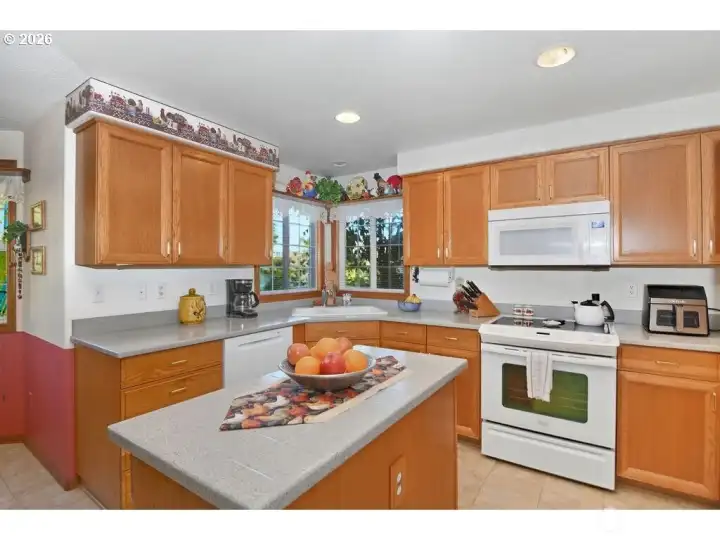 Kitchen features refrigerator, oven, dishwasher, built-in microwave, island, and pantry.