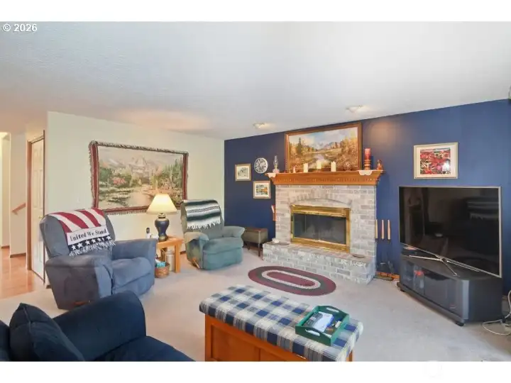 Family room features a cozy gas or wood-burning fireplace.