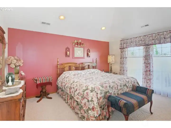 Primary suite features an attached bathroom and dual closets.