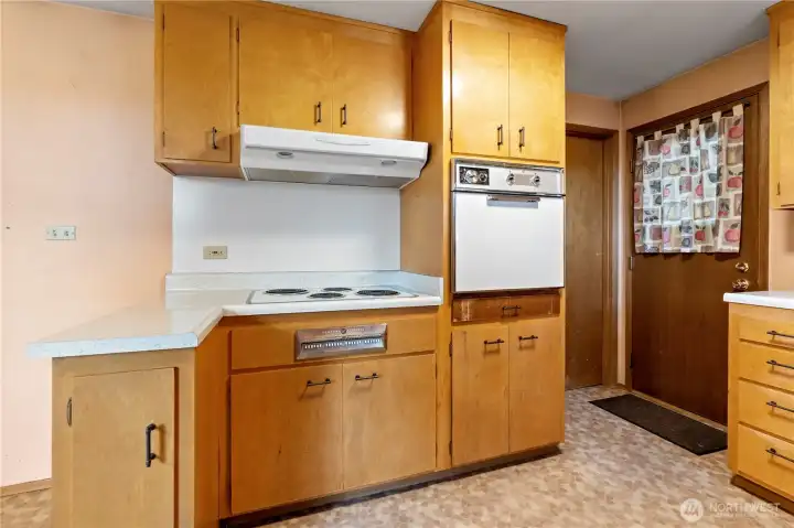 Door to basement and back door from carport are off the kitchen