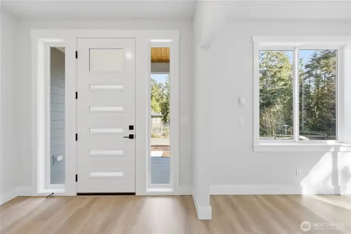 As you enter, custom front door with side lights, to the right is the bonus office space.