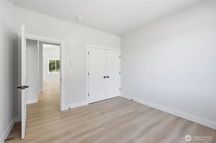 Bedroom #2, solid closet doors, custom features throughout home.