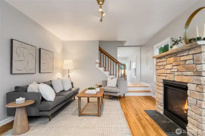 The living room features a charming stone gas fireplace.