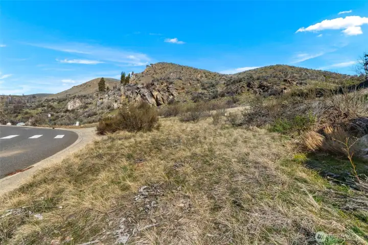 View from the SE corner of the lot. Note the dramatic rock formations that could serve as a backdrop to natural landscaping.