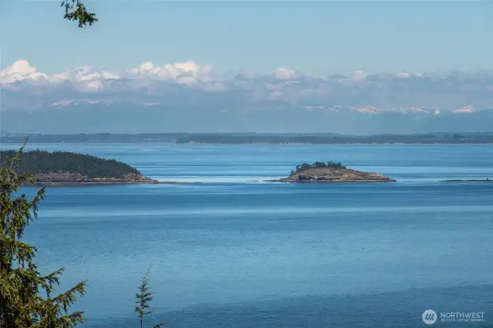 Matia and Puffin Islands sit in the foreground of this expansive water view, with the snow-capped Canadian Cascades beyond. The light, water, boats, birds, and weather are always changing, making the view endlessly engaging. Matia and Puffin Islands sit in the foreground of this expansive water view, with the snow-capped Canadian Cascades beyond. The light, water, boats, birds, and weather are always changing, making the view endlessly engaging.