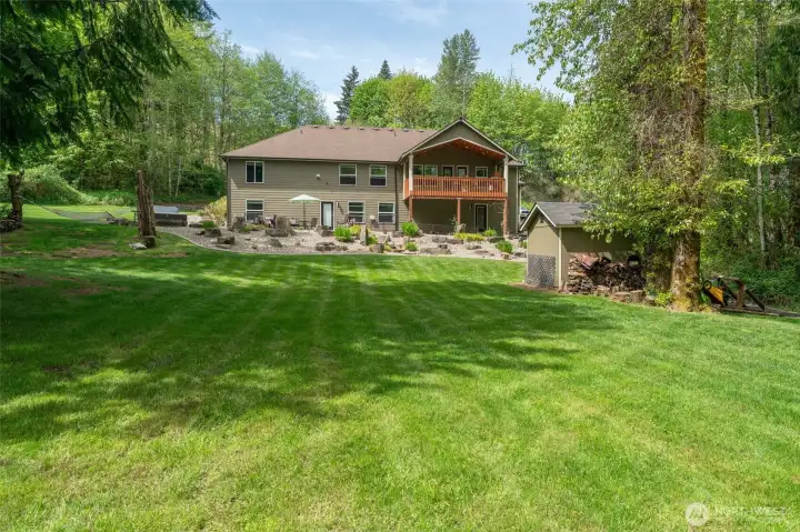 Rear view of home with the sprawling lawn.