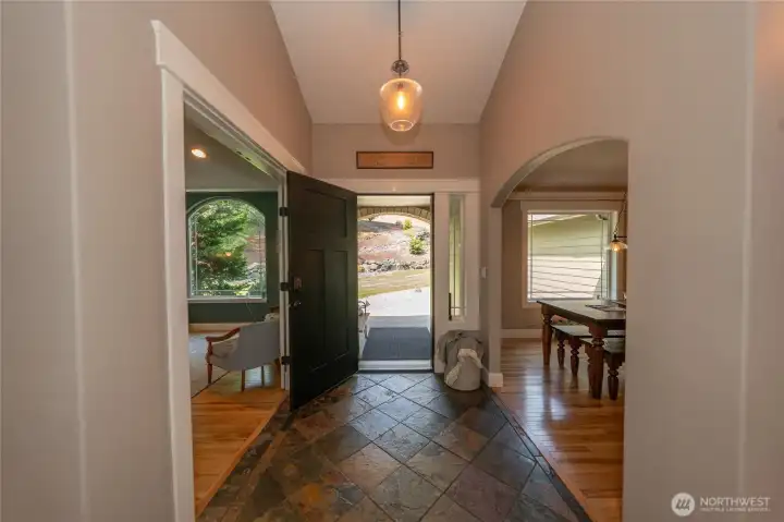 The front porch is covered and leads into the large foyer which has slate tiles.  On one side is the den and the opposite side is the dining room,