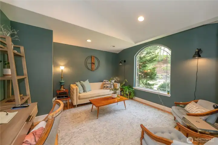 Newer light fixtures in the house-this has plug in wall sconces in the den-notice the vaulted ceiling!  Glass French doors keep this office room private for your work conversations or make it a private library or study room!