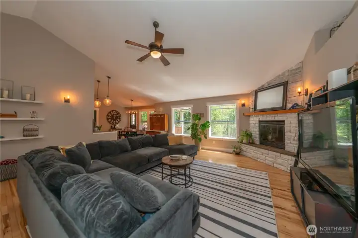 Notice the vaulted ceiling in the living room with overhead light fixture and fan.
