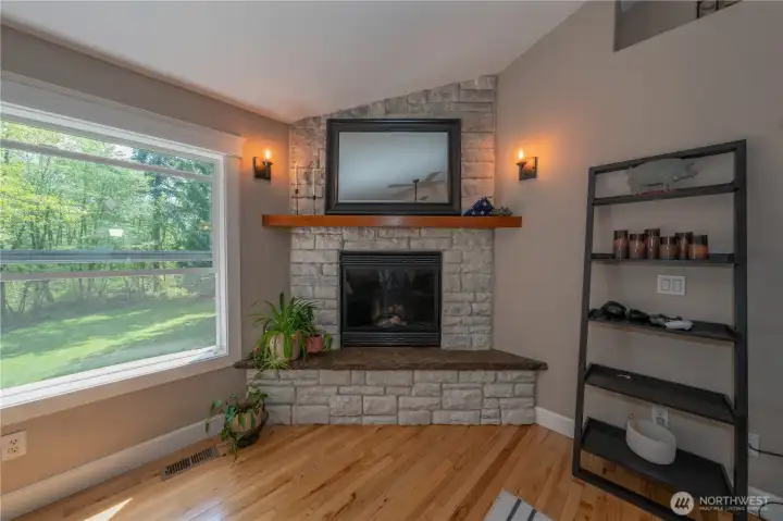 The fireplace in the living room is fueled with propane gas.  The living room is adjacent the kitchen eating nook and kitchen breakfast bar.