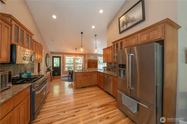 The kitchen has vaulted ceilings and a few past the eating nook to the backyard and the scenic trees on the eastern part of your yard!