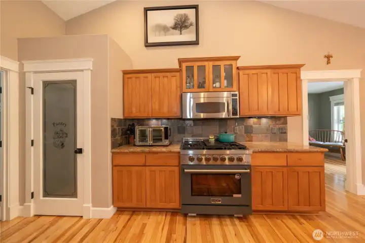 There is a walk in pantry and on the left is the door leading to the laundry room/mudd room and the 3 car garage.