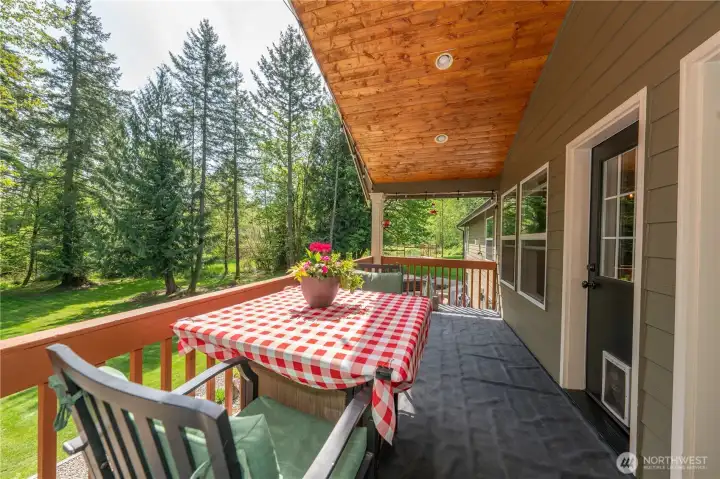 The deck has two entrances, one from the kitchen eating nook and the other entrance from the primary bedroom-notice the detail to the overhang!