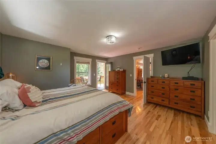 Primary bedroom has hardwood floors-so easy to clean!  There is an entry door to the covered back deck from here and there is a door from the kitchen eating nook to the deck.