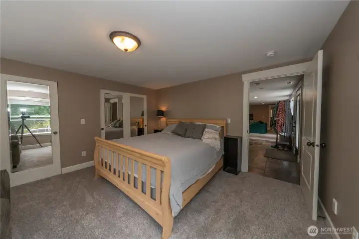 This ground level bedroom has a wall of closet space and the entrance to the walk-in crawl space which is dry and has been used for storage.