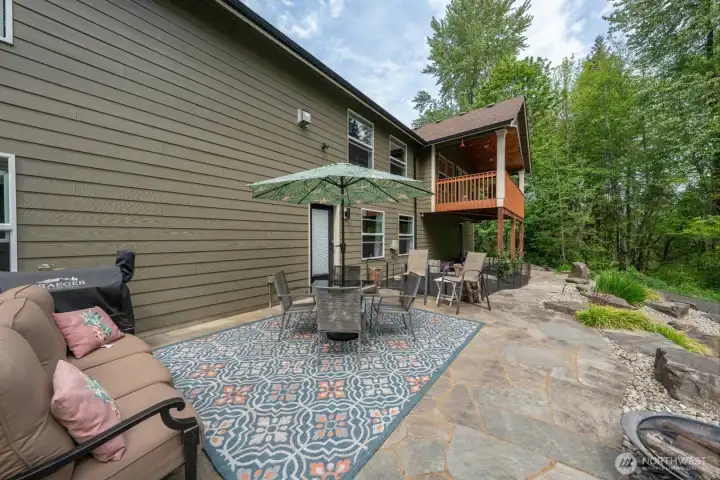 View of the patio which is in excellent condition and there are two doors leading from the back patio into the ground level, daylight basement,