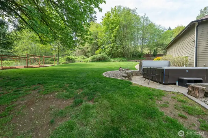 View of the side yard as you are next to the hot tub looking towards the west and the front yard.