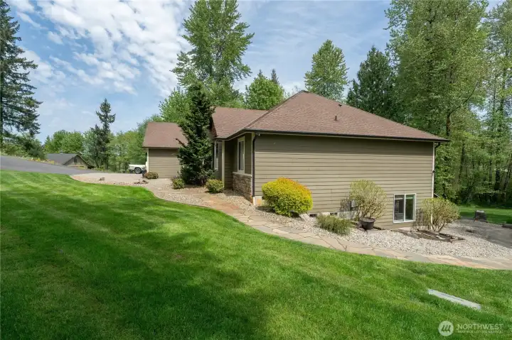 View of the side yard which the hot tub is on the right of this pictures