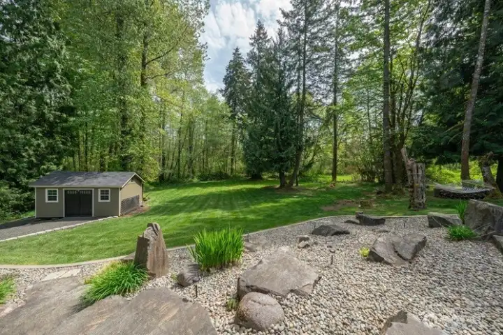 Manicured lawn sprawling in the back, on the side and in the front!  This pictures shows the side driveway entrance to the backyard shed.
