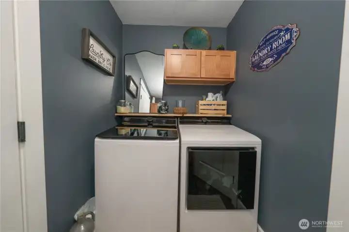 Full sized washer and dryer on one side of the laundry room