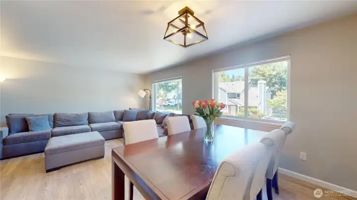 Adjacent to the living room and flowing seamlessly to the kitchen lies the dining room with updated lighting fixtures. Adjacent to the living room and flowing seamlessly to the kitchen lies the dining room with updated lighting fixtures.