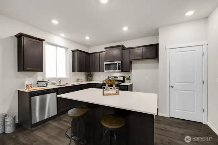 Island in kitchen with room for barstools. Photos are for representational purposes only, colors and features may vary. Island in kitchen with room for barstools. Photos are for representational purposes only, colors and features may vary.