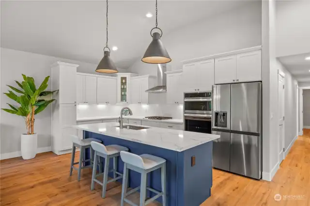 Island seating and pendant lighting add charm and functionality to this stylish kitchen.